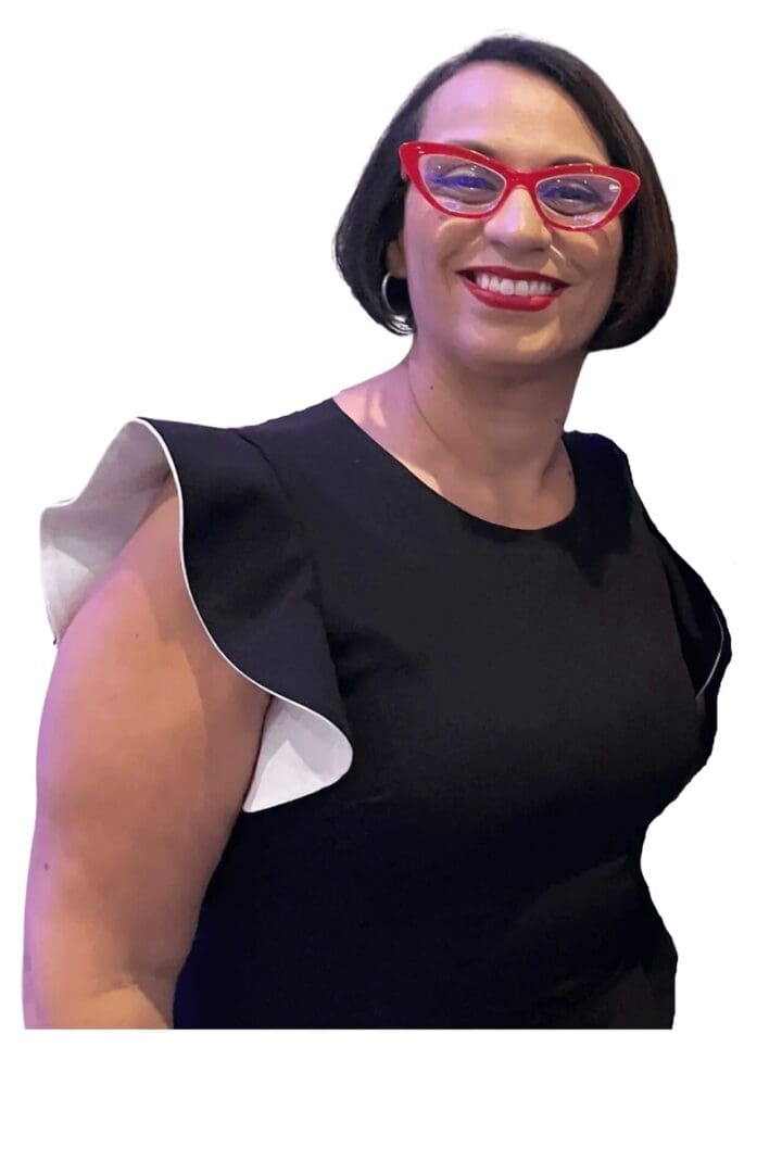 A woman in glasses and black dress smiling.